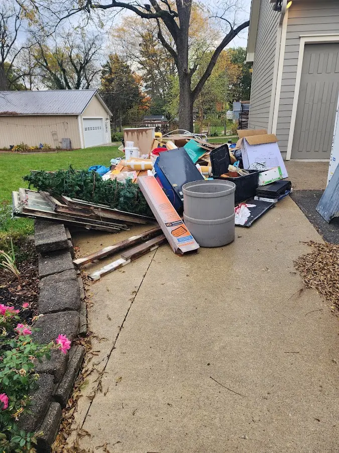 Dumpster being loaded with debris for Roofing Dumpster Rental in Sumner